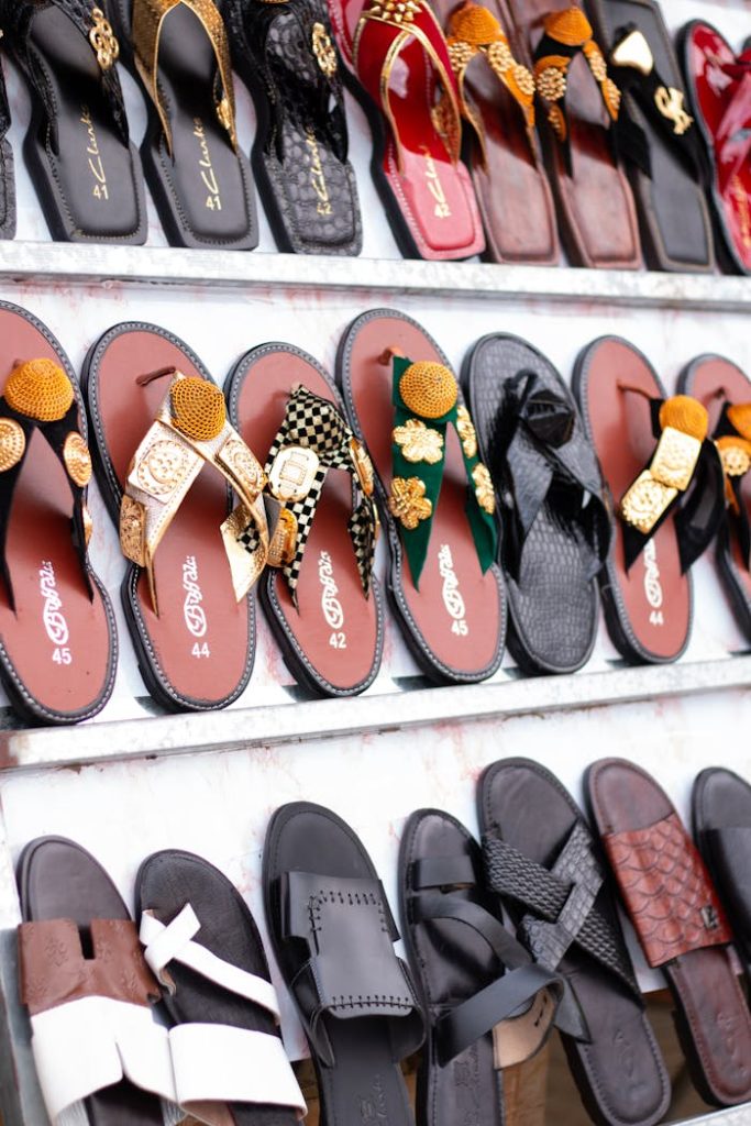 Vibrant collection of decorative sandals arranged on shelves, showcasing diverse designs and colors.